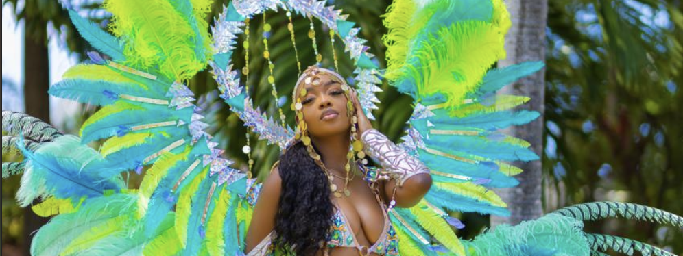 Jamaica Carnival masquerader on stage in a Carnival Glam Hub costume