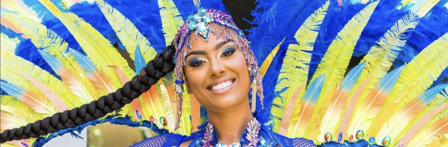 Jamaica Carnival masquerader in a blue and yellow costume